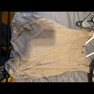 Beige tank top with mesh cut out sides.